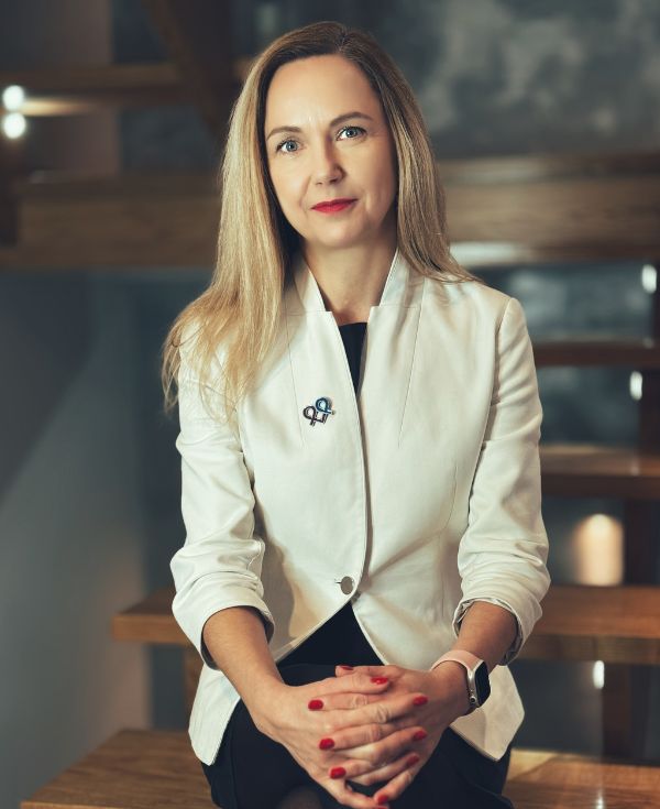 Kobieta o blond włosach w białej marynarce